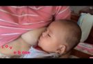 A young Indonesian mother lovingly breastfeeds her baby