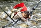 A primitive fishing method, on a river during the rainy season.