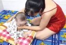 Breastfeeding and playing with baby Thinh